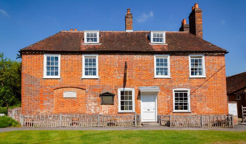 Historic red brick Chawton cottage exterior where Jane Austen lived and wrote