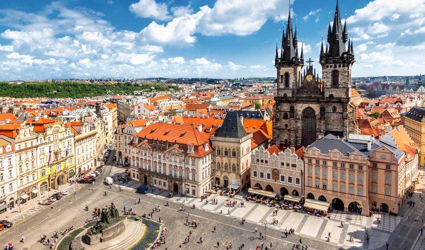 Prague Old Town Square featuring the Gothic spires of Týn Church and historic city buildings