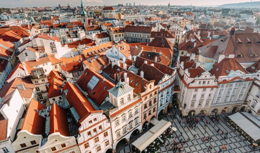 Aerial view of Prague's Old Town featuring red-tiled roofs and historic architecture