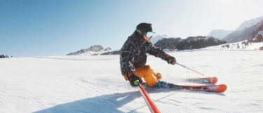 a person skiing on snow laden Dolomite slopes