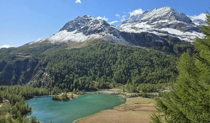 Sunny panoramic view of the mountains and lake in St. Moritz